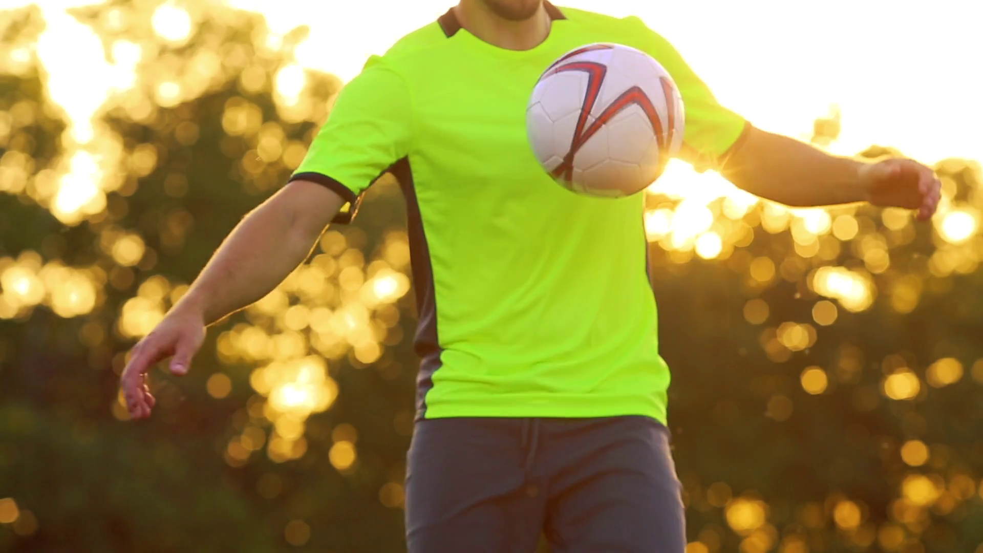 A professional football player and a man in a green uniform, knees