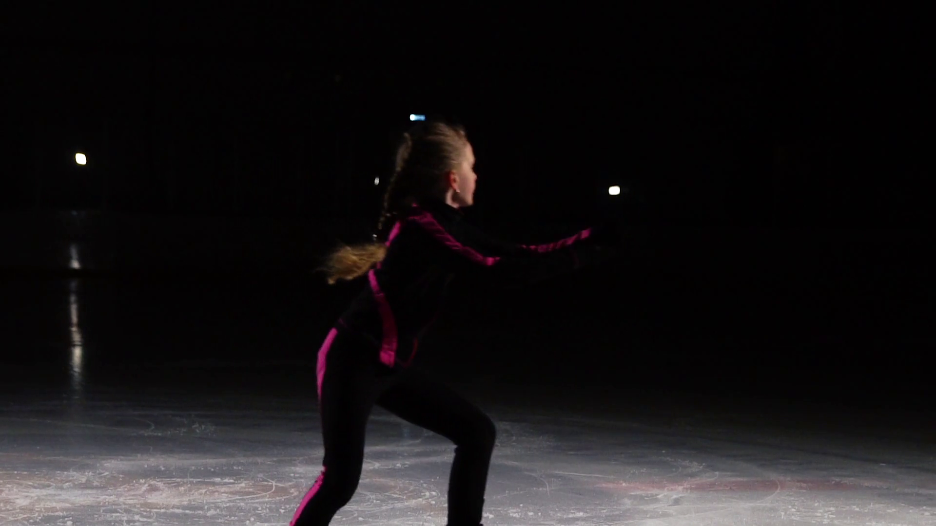 A professional skater performs a skating jump with the rotation in the