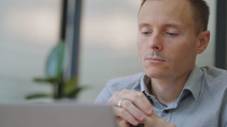 Talented individual working with laptop in cafe. Freelance, remote work, online education.