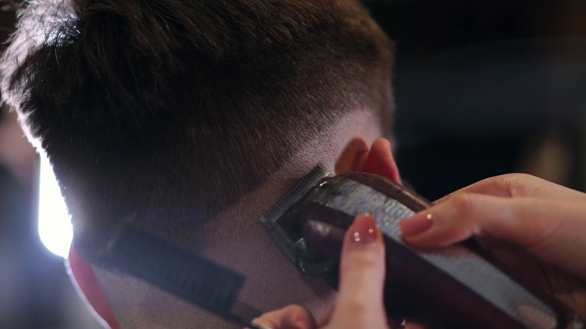 Male haircut with electric razor. Close up of hair trimmer hairstyle