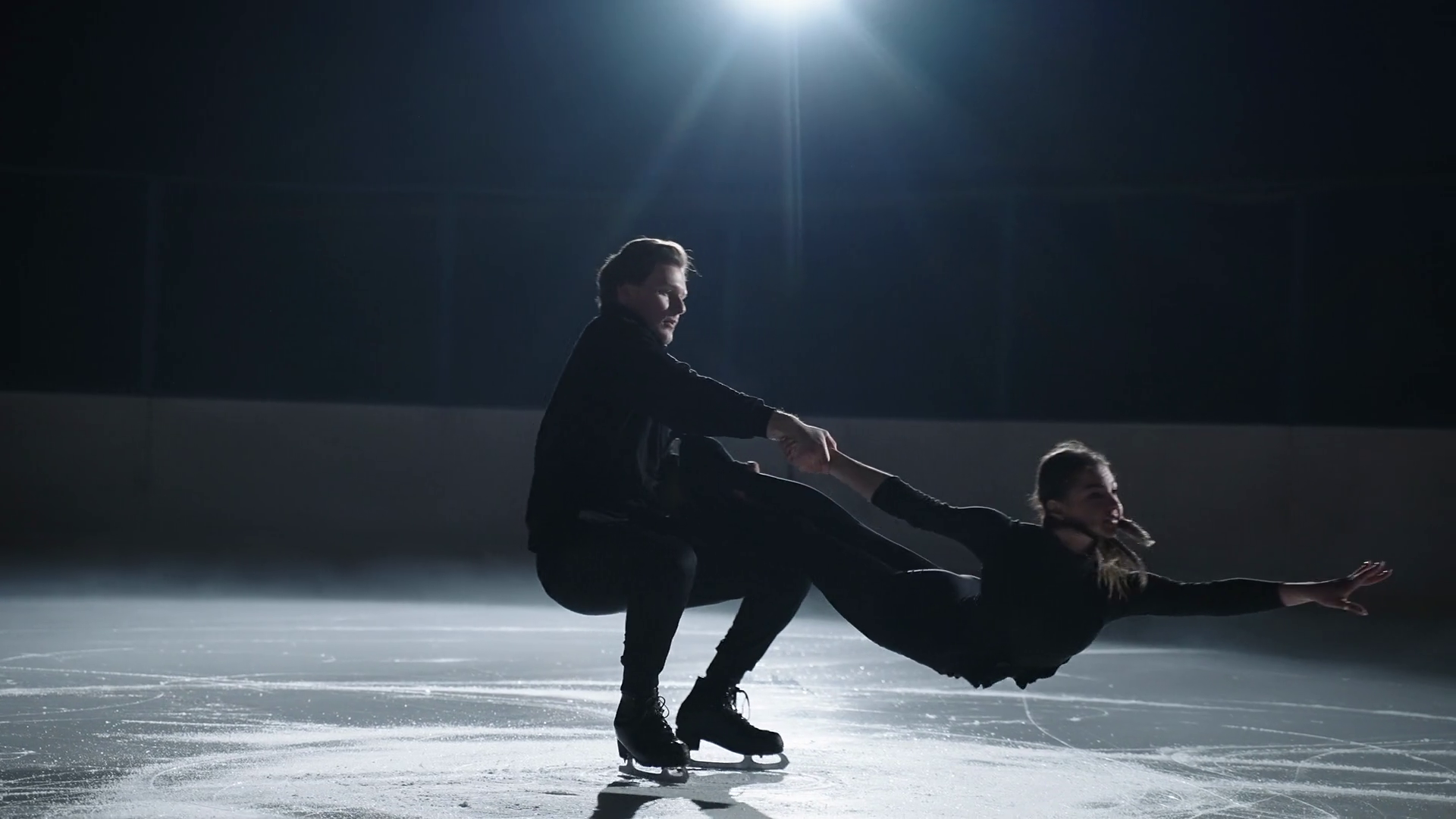 pair figure skating training, strong sportsmen is holding his female