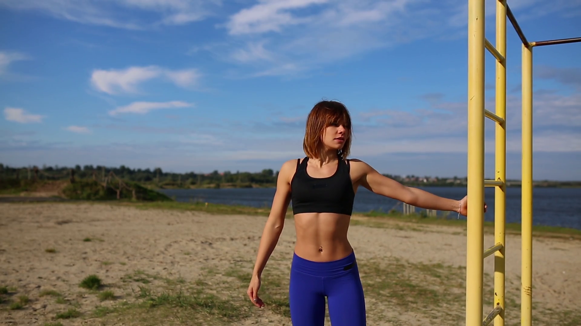 The girl in the hoodie, comes to the river, removes his jacket and