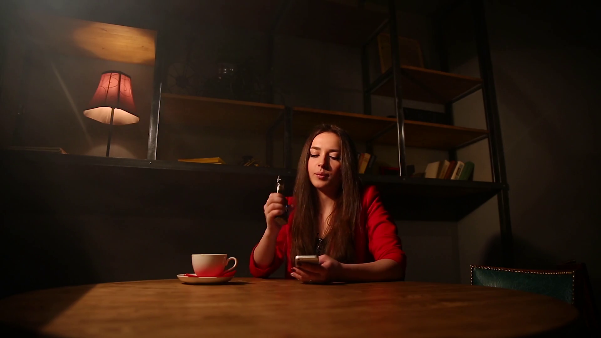 The girl in the red jacket Smoking the electronic cigarette and talking