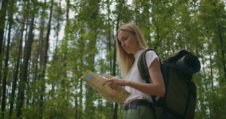 Exploring the Forest: Woman Finding Her Way with a Map