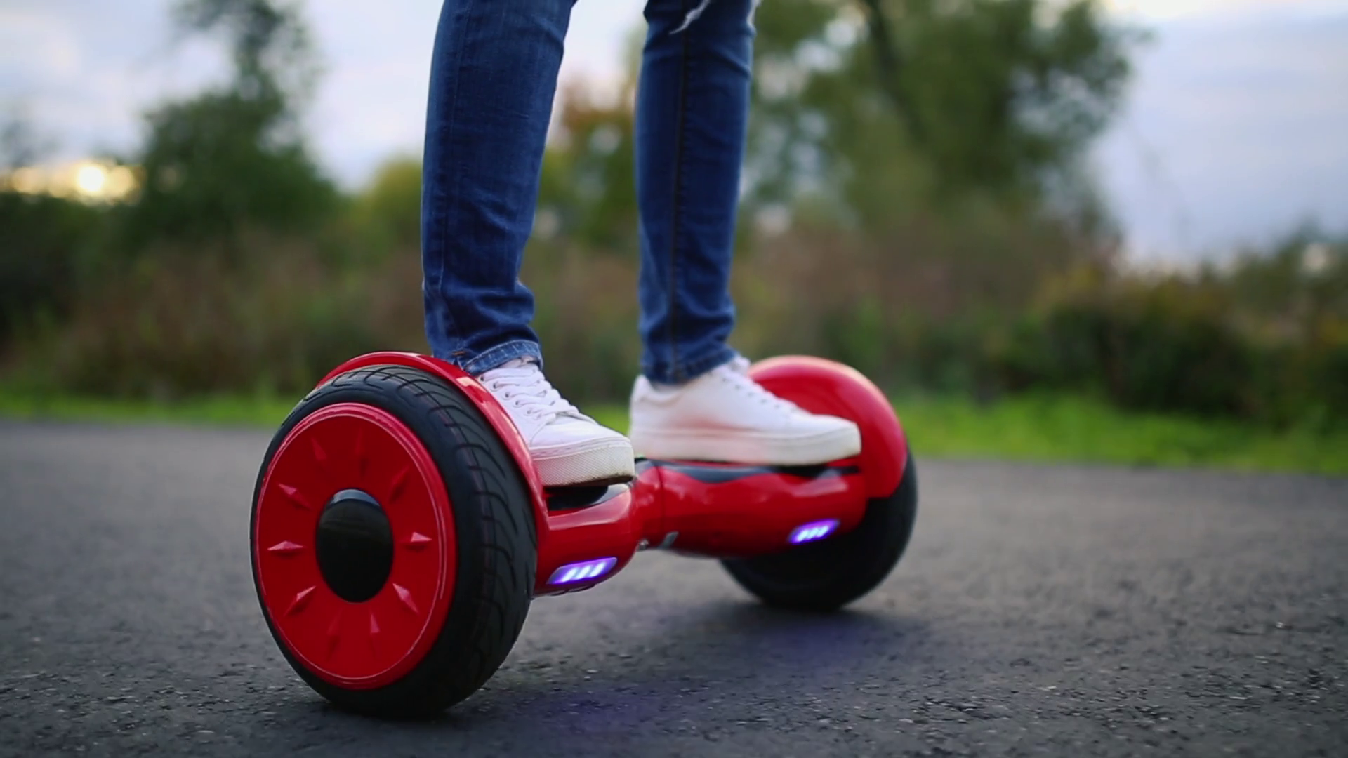 young man riding on the Hoverboard in the park. content technologies. a