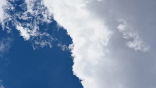 dynamic cloud movement in the blue sky
