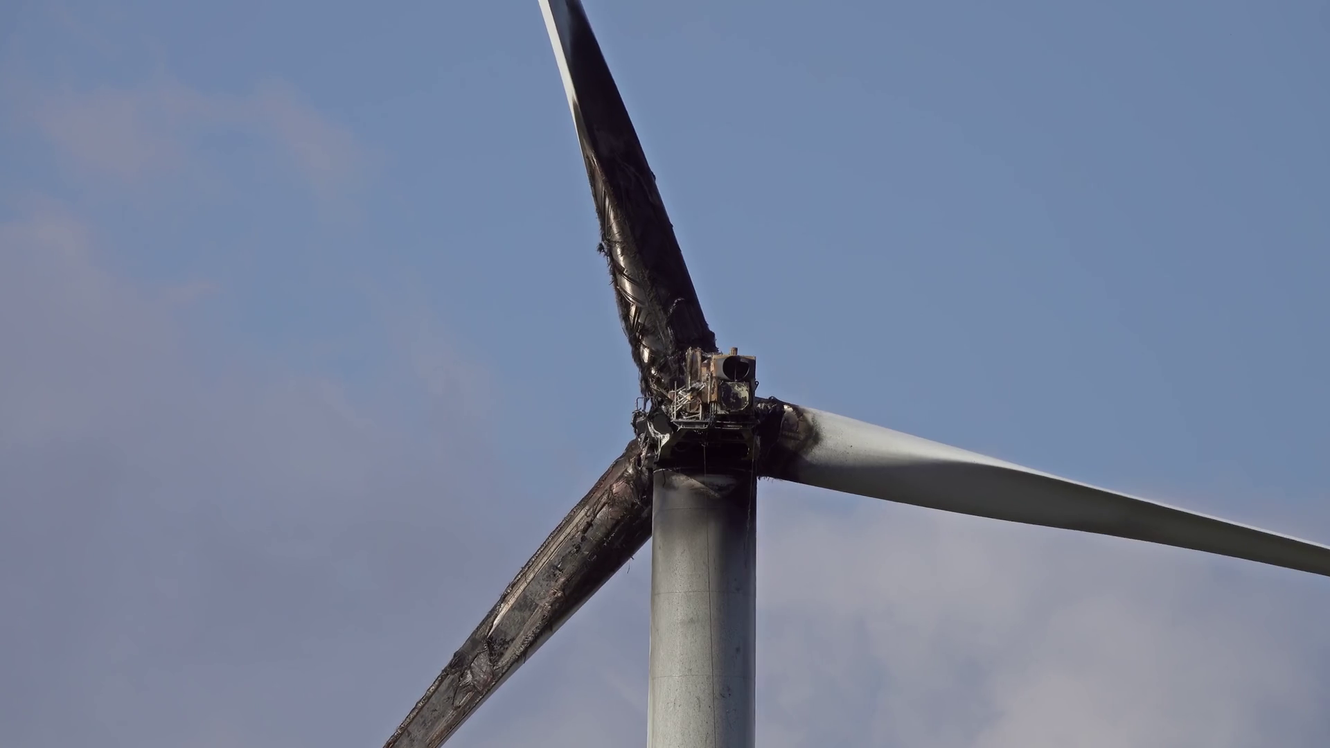 Burned Damaged Wind Turbine Against Blue Sky Stock Footage SBV
