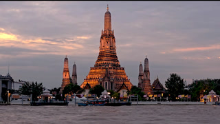 Discover the enchanting beauty of Wat Arun Temple as the sun sets over Bankok, Thailand. Experience the peaceful ambiance and stunning