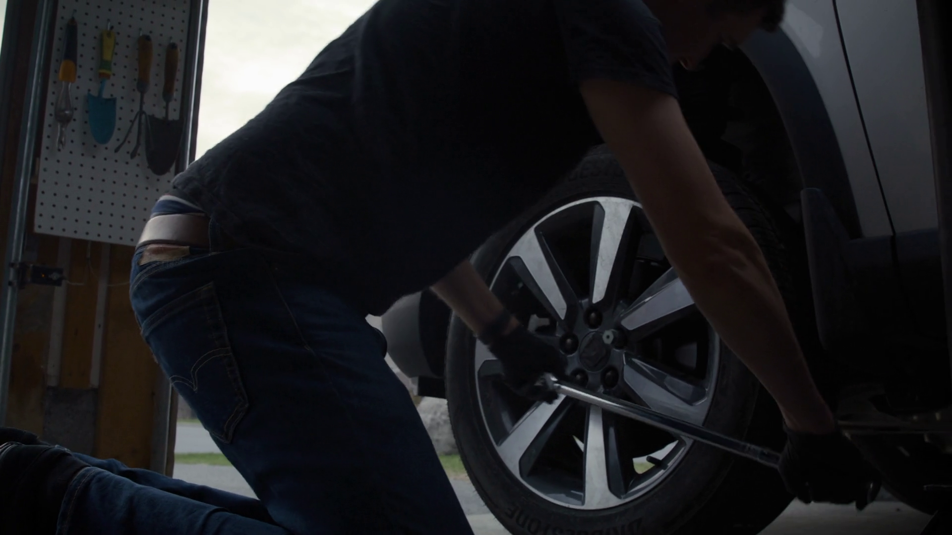 Handy Man Mounts Car Wheel Onto Car In Home Stock Footage SBV-352115206 ...