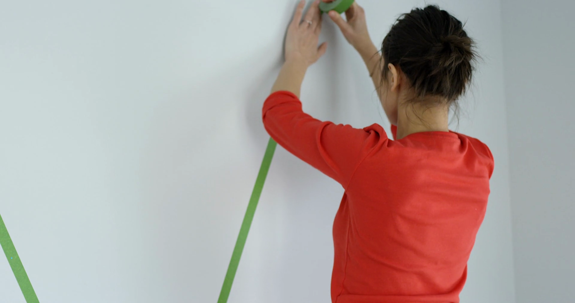 Woman Putting Painters Tape Up On Bedroom Stock Footage SBV348451905