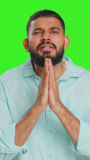 Indian sad man praying making wish, asking hopeful help, begging apology, meditation, imploring