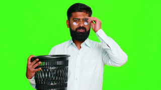 Indian man smiling removing glasses and tossing them away showing eye correction vision freedom