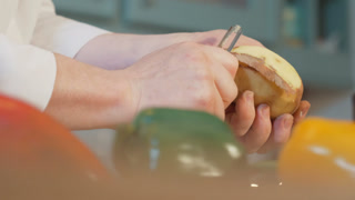 Chef hands peels potatoes 4k