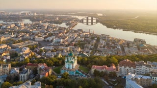 Kyiv \ Kiev, Ukraine. Aerial hyperlapse of Kiev old city center. Flying over St. Andrew's Church and Podol at sunrise. UHD 4K
