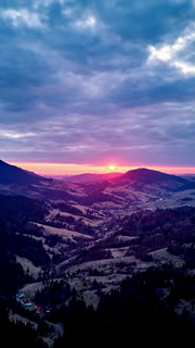 Vertical Aerial Hyperlapse of Colorful Sunset Over Mountain Ridges