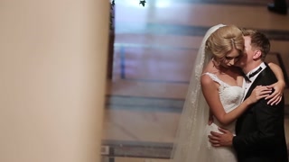 Bride and groom embracing in palace