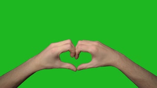Person showing heart with his hands. Man arms in shape of symbol of love gesture