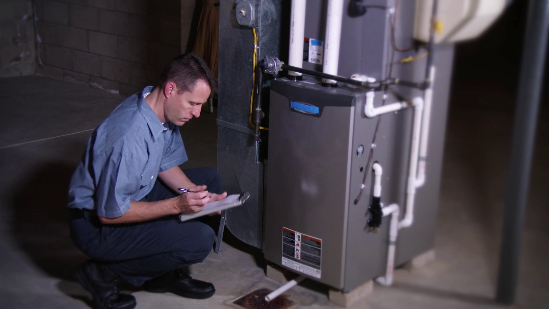 Furnace Repairman Inspects Unit In Home Stock Footage SBV300324373