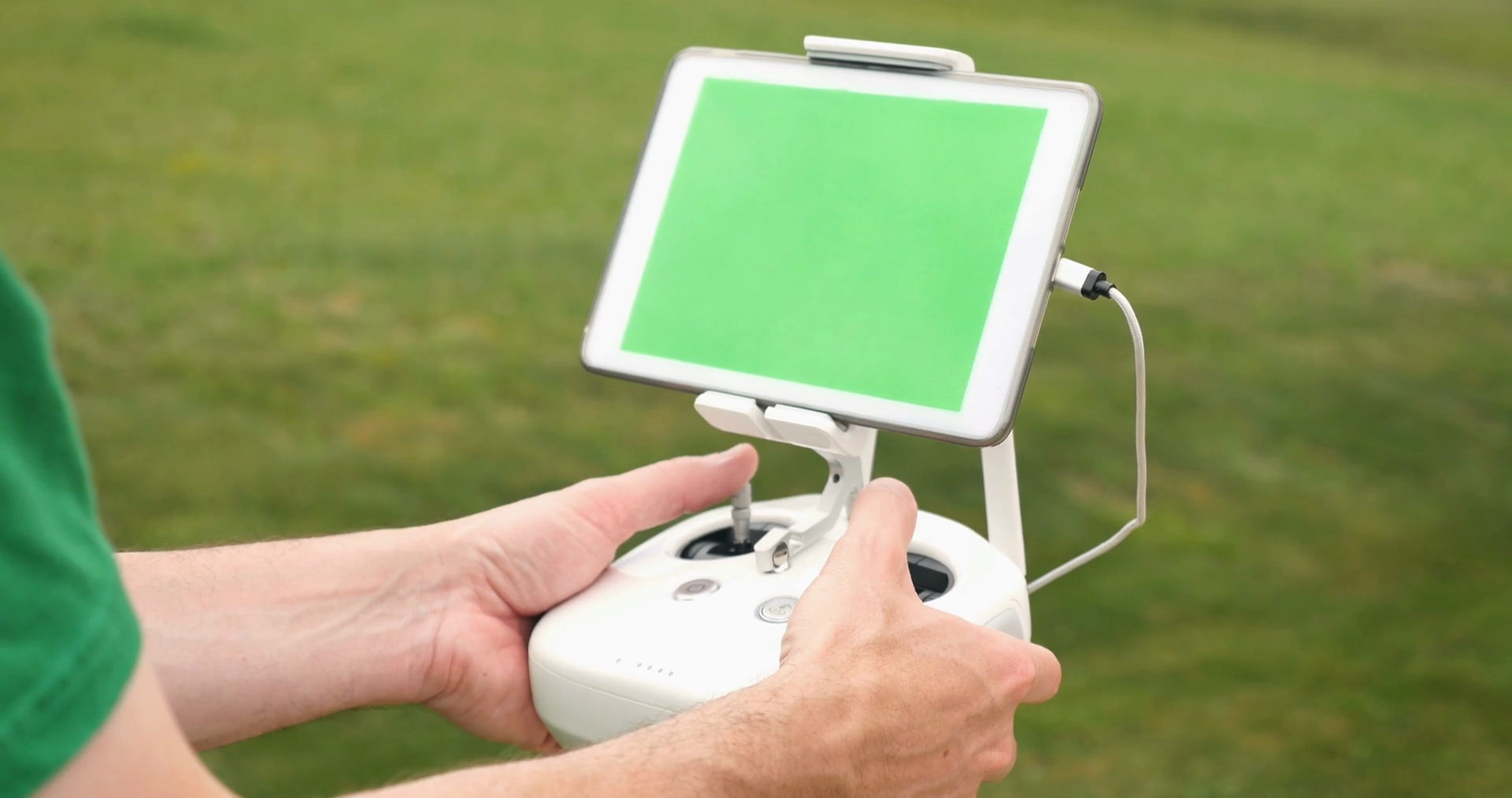 A Man Uses A Rc Controller For A Drone Or Uav Outside In An Open Field Green Screen Generic Tablet With Optional Corner Markers For Advanced Screen Tracking Stock Video Footage