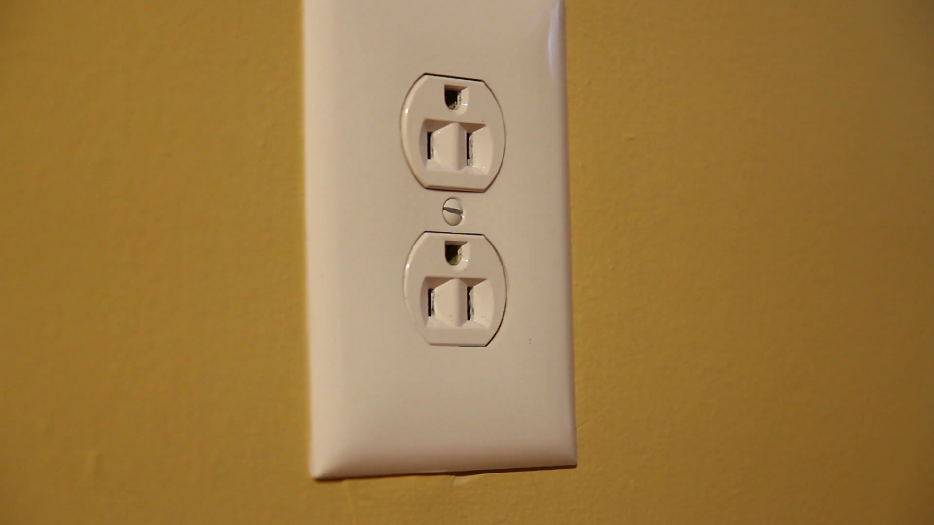 Plugging in Extension Cord in Wall Socket Detail Stock Video Footage 00