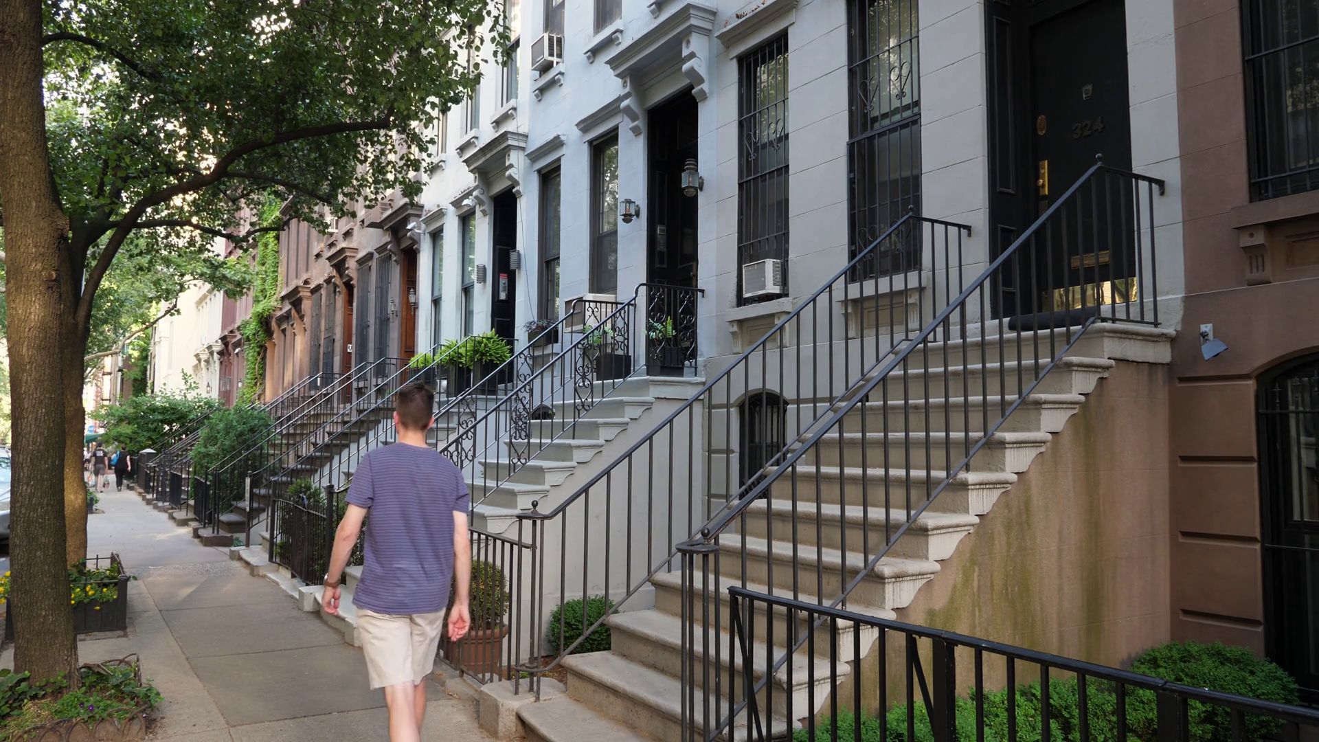A daytime establishing shot (DX) of typical upscale row houses or