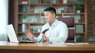 Asian teacher consultant lecturer doing online video meeting consultation conference sitting at workplace in office class consultant using laptop computer. training, virtual webinar. Asia