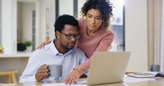 Stressed couple on laptop looking at debt finance paper work, trouble paying insurance loans or online ebanking together at home