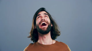 Funny, face and man in studio laugh with happiness, freedom or reaction to crazy joke