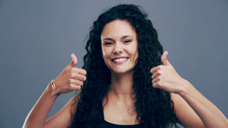 Woman, thumbs up and happy for success, winning and thank you or support, like emoji and vote in studio