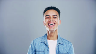 Happy, face and man laughing in a studio for funny, comic and silly joke with confidence