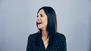 Happy, face and woman laughing in a studio for funny, comic and silly joke in conversation