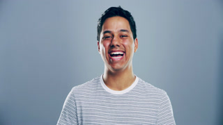 Happy, face and man laughing in a studio for funny, comic and silly joke in conversation