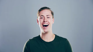 Happy, face and man laughing in a studio for funny, comic and silly joke in emoji