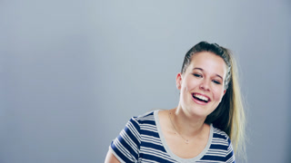 Funny, face and woman laughing in studio for comic or silly joke and emoji with happiness