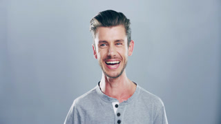 Funny, face and man laughing in a studio for comic or silly joke in communication with happiness