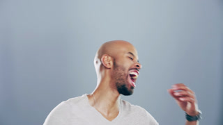 Comic, face and man laughing in a studio for funny or silly joke in conversation with happiness