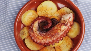 Octopus cooking, chef grill fresh octopus galician style on restaurant kitchen, healthy food, seafood cafe in spain, traditional asian