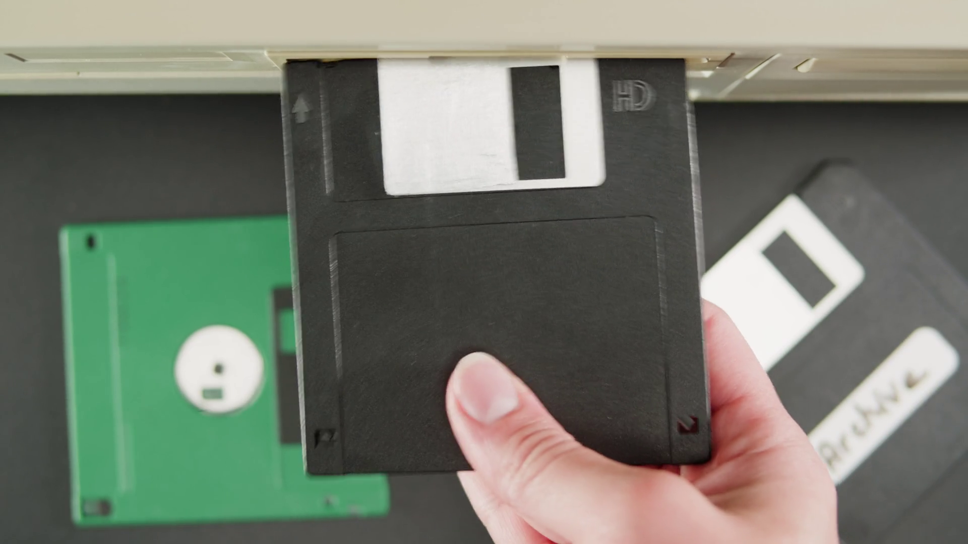 Using fdd diskette closeup. Old floppy disk, disc drive top view