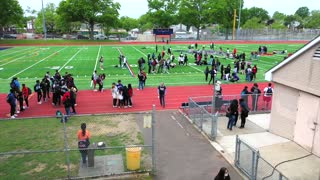 Low Overhead Shot Of Teenagers Playing On The Football Field