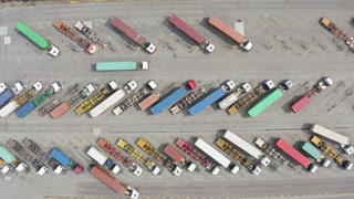 Aerial view of white trucks with cargo trailer parking on special parking lot.