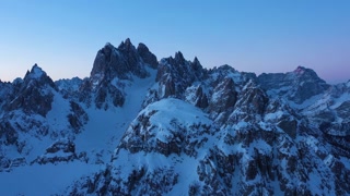Cadini di Misurina Mountains at Winter Morning Twilight. Blue Hour. Aerial View. Sexten Dolomites, Belluno, Italy. Orbiting