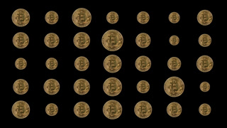 A macro shot of bitcoins growing and shrinking against black.