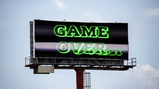 large outdoor advertising screen with arcade game over on the screen
