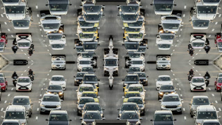 traffic on a highway in barcelona during evening rush hour made into abstract mirrored pattern