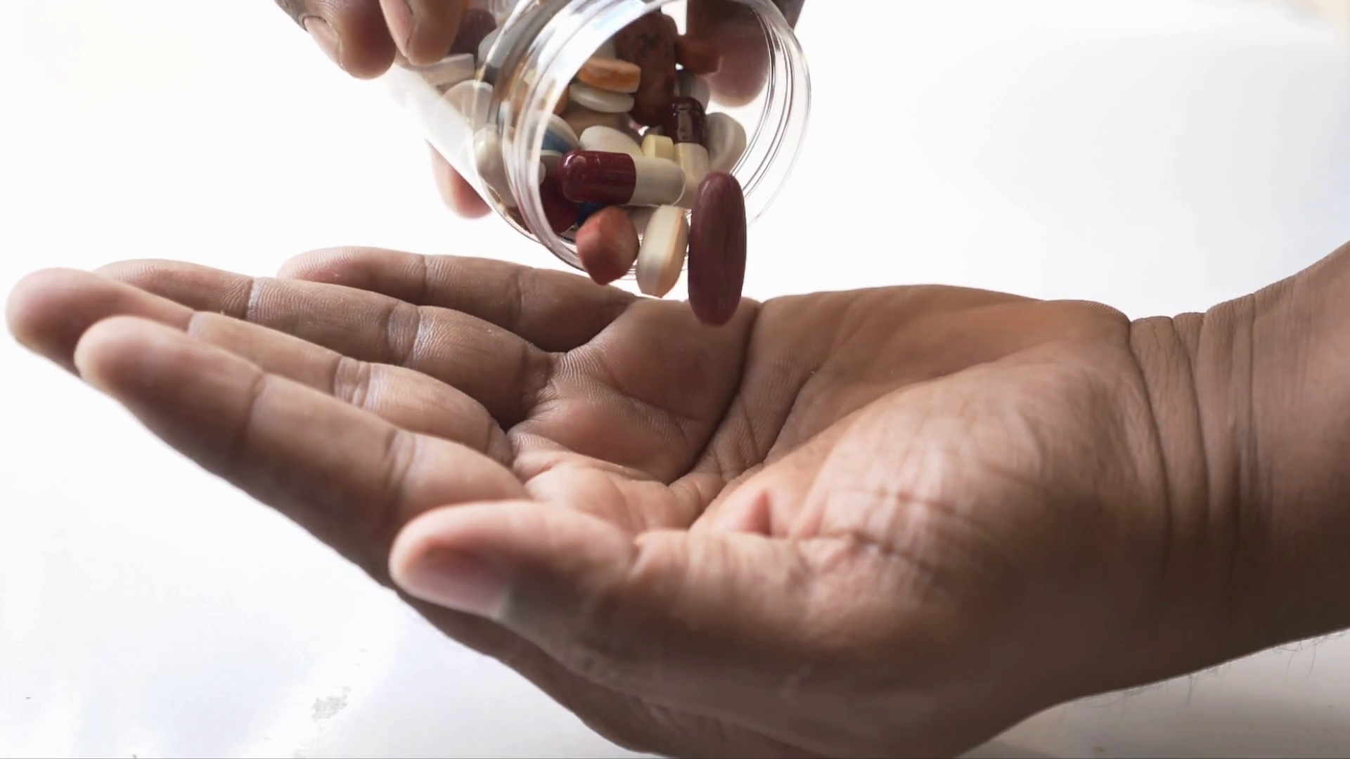 Pills being poured into hand in slow motion capsule Stock Video