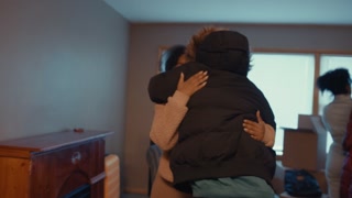 Handheld shot of woman hugging her friends goodbye after helping her move