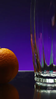 Beautiful drink is poured into transparent glass. Stock clip. Bright drink is poured into glass on background of ingredients. Fruit around