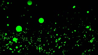 Big green glitter on a black background. Motion. Flying green particles made in cartoon animation.