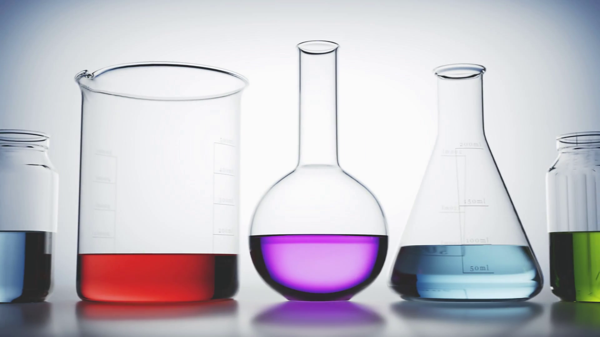 Versatile laboratory glassware with colorful liquids inside on a light