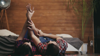 beautiful enamored couple are touching by each others hands in the bedroom on Saint Valentines day